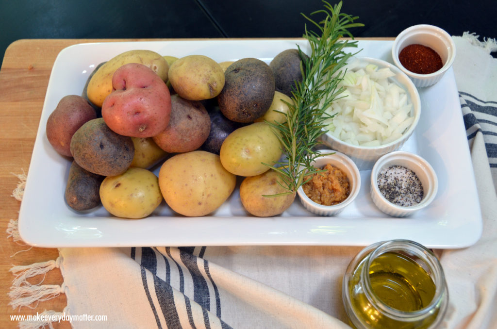 Rosemary potatoes on platter on cutting board watermark